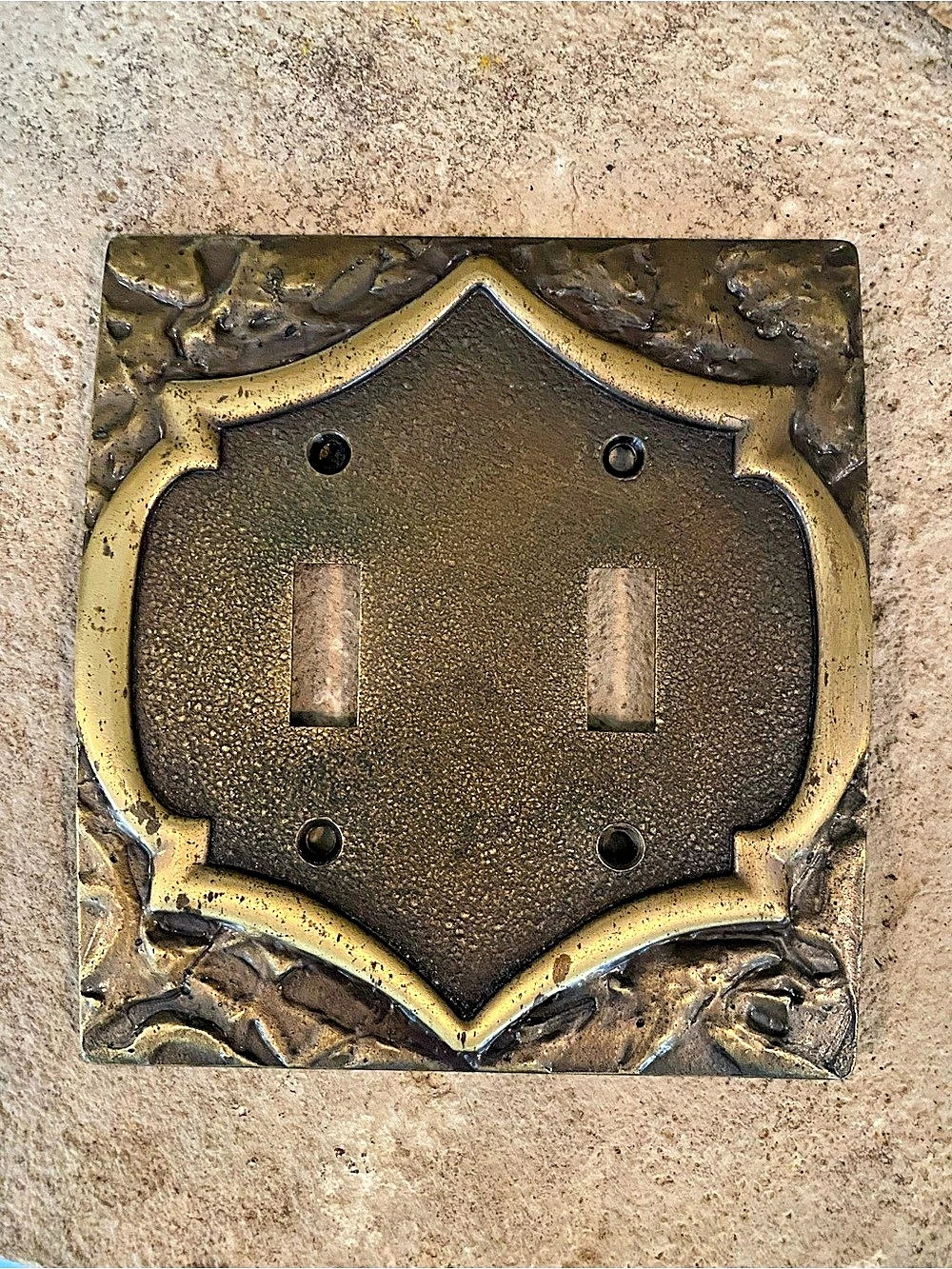 Vintage 1970s metal light switch cover.